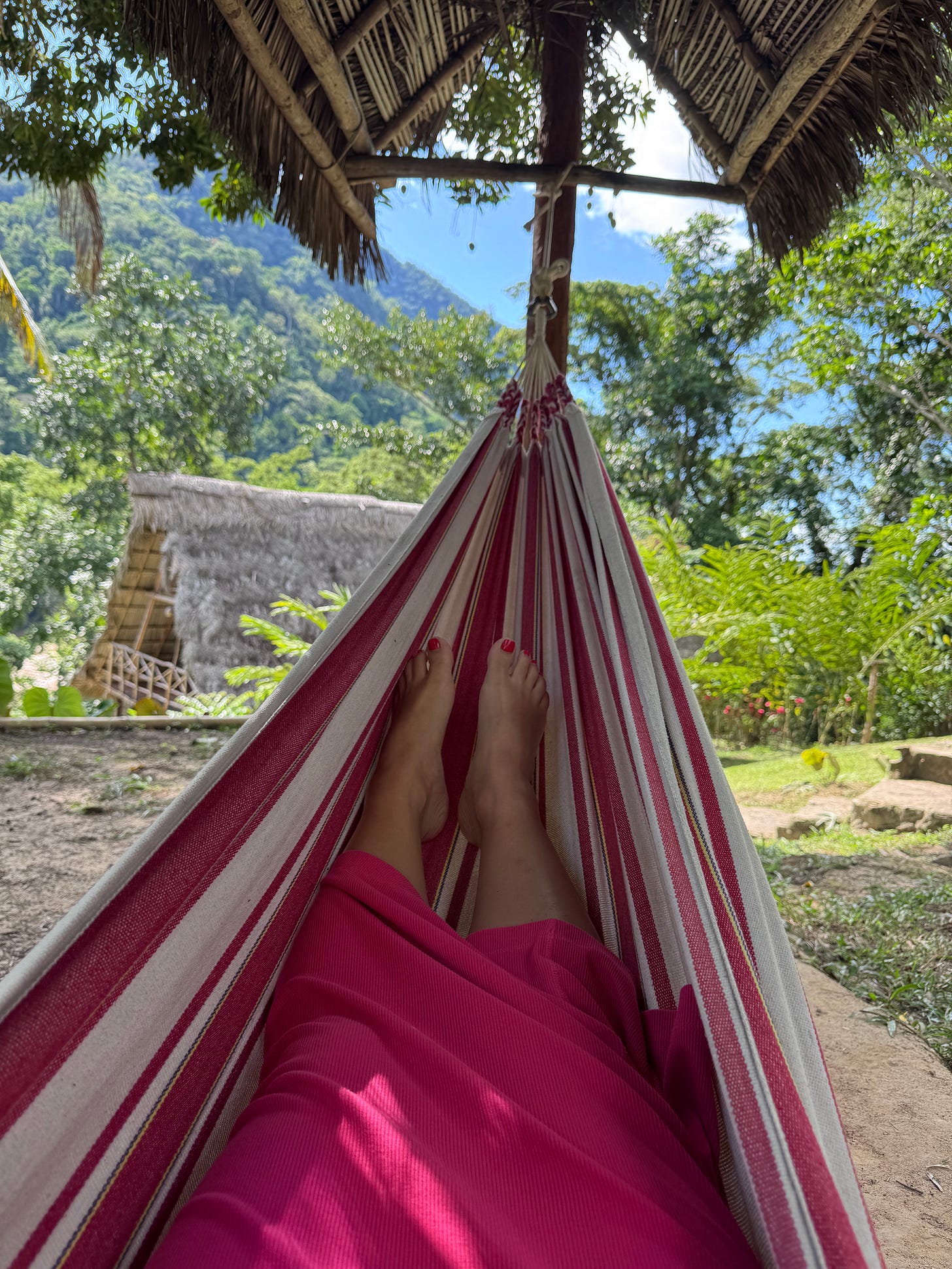 Legs spread on a hammock in the Peruvian jungle