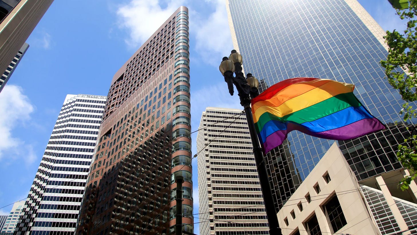 Pride flag with corporate buildings in the background Pride flag with corporate buildings in the background