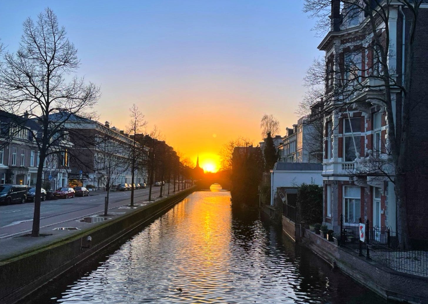 sunset over a canal in a city