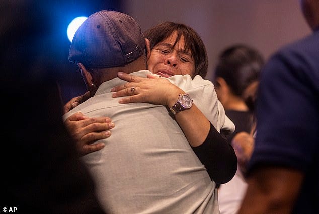 Attendees embrace during a church service at King's Cathedral in Kahului on the island of Maui, Hawaii Sunday, August 13