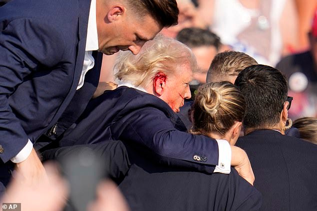 Blood can be seen pouring from the side of the former president's head