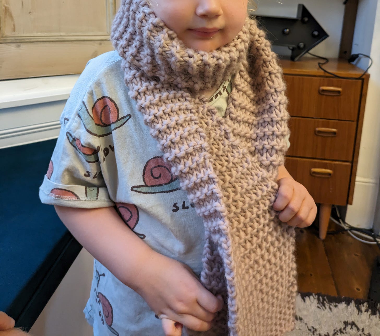 Scott's daughter wearing a hand-knitted scarf