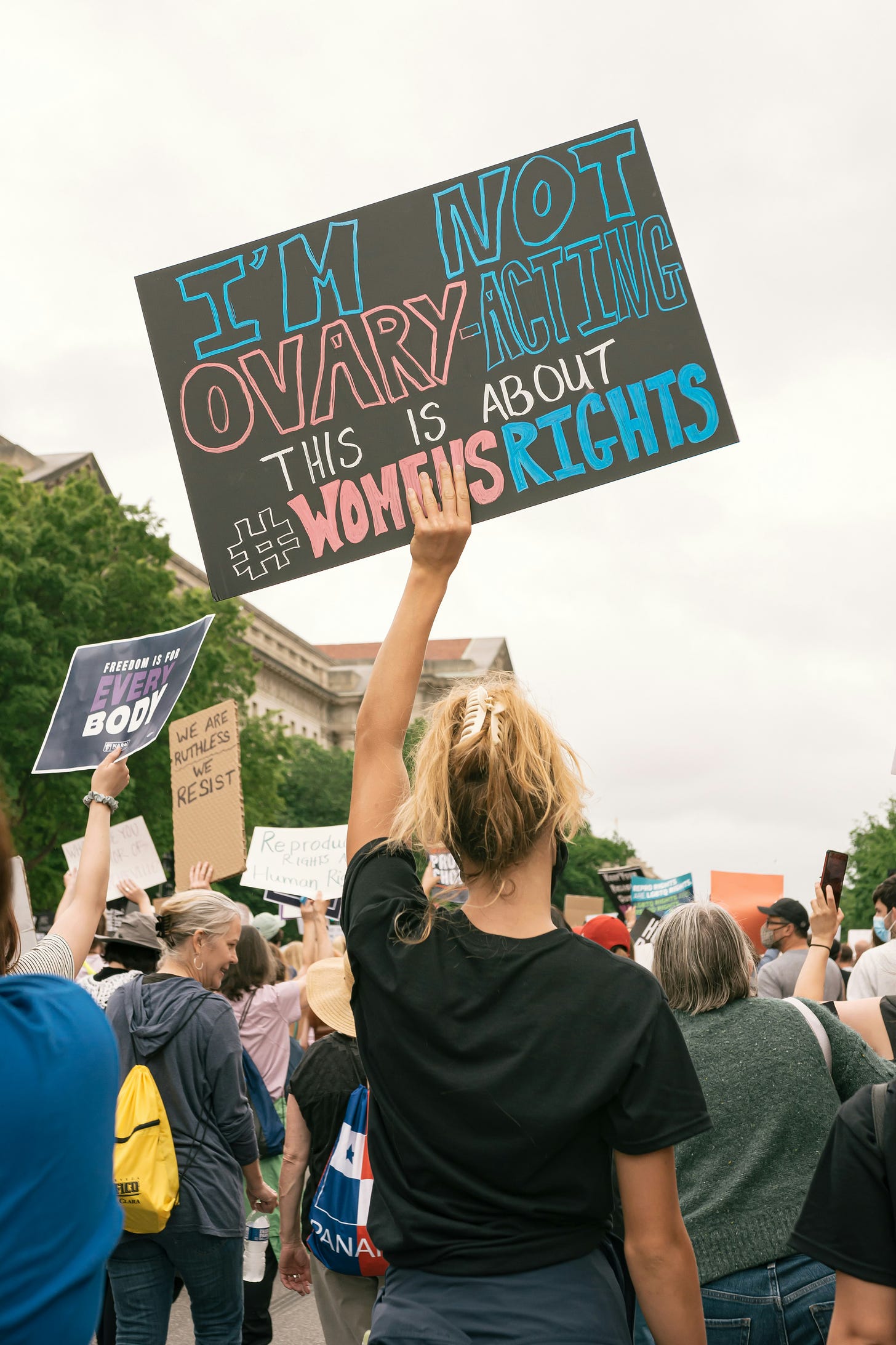 Photo of a protestor holding up a sign that reads: I'm not ovary-acting, this is about #womensrights