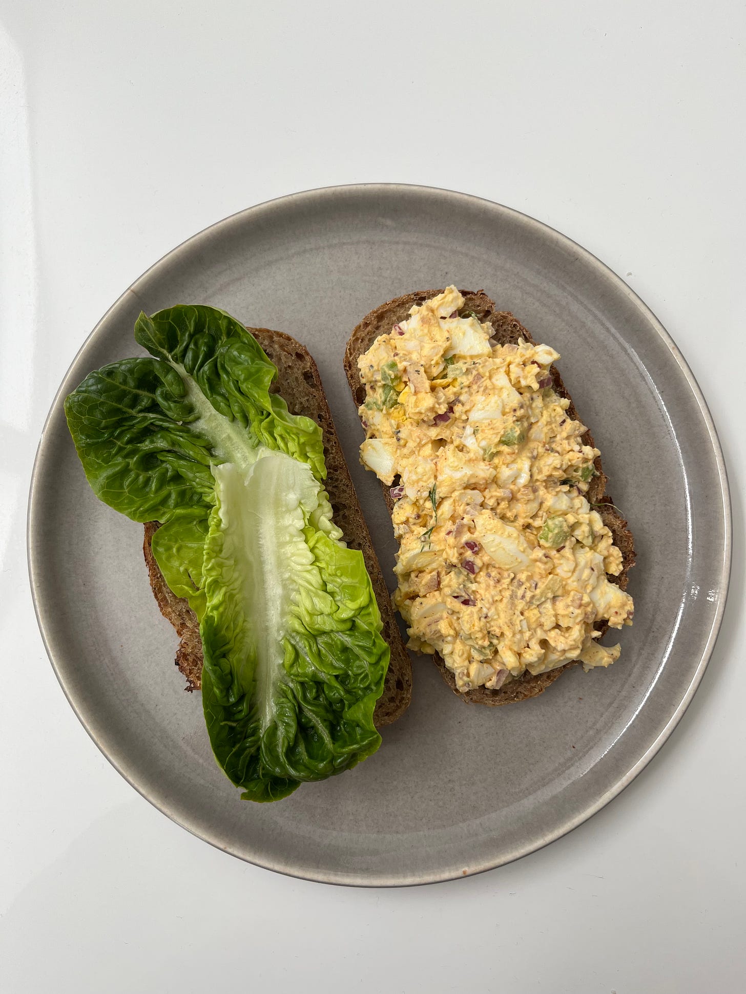egg salad sandwich on a grey plate