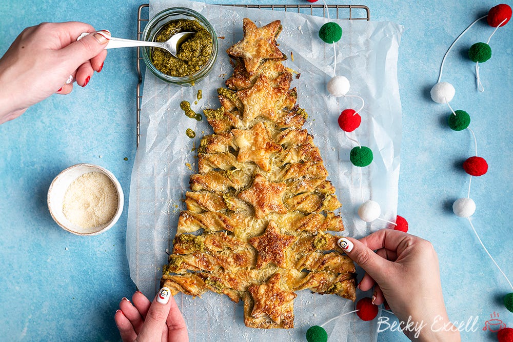 Becky Excell Gluten Free pastry christmas tree baked and having green pesto drizzled over it.