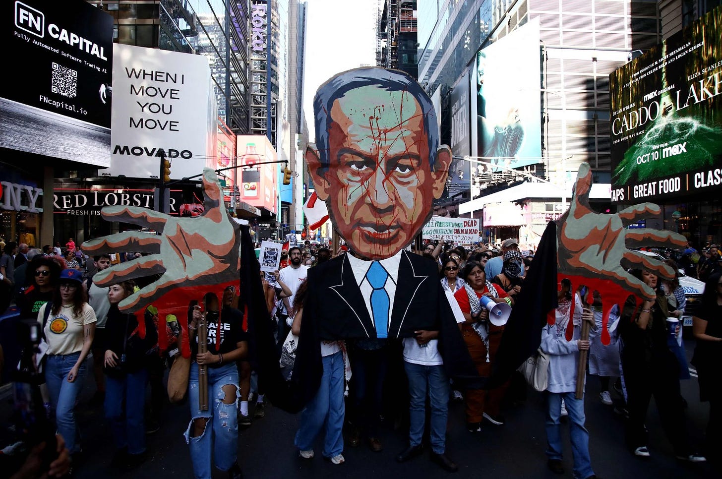 People hold an image of Prime Minister of Israel Benjamin Netanyahu with blood on his face as they demonstrate to mark one year of Israel&#039;s attacks on Gaza, New York, U.S., Oct. 5, 2024. (AFP Photo)