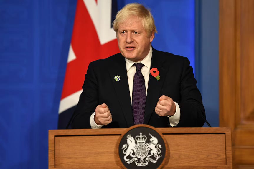 Man in a suit behind a podium gives a press conference.