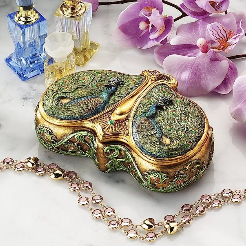 Summer Zodiac Sign Gift Guide: a golden highly-decorated peacock jewelry box by Design Toscano