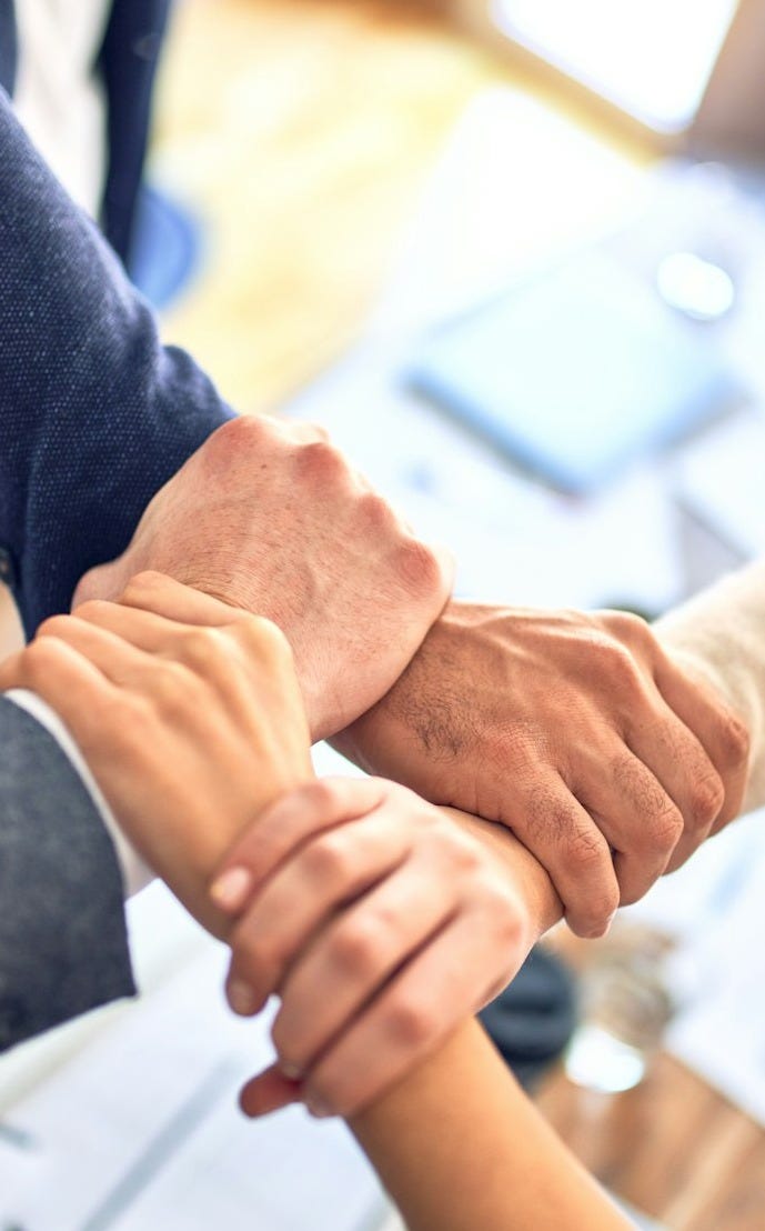 person in black long sleeve shirt holding persons hand