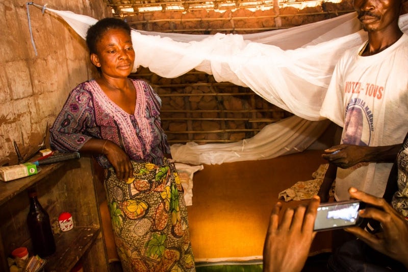 “A woman poses for a picture in front of her net.” Photo and caption courtesy of AMF.