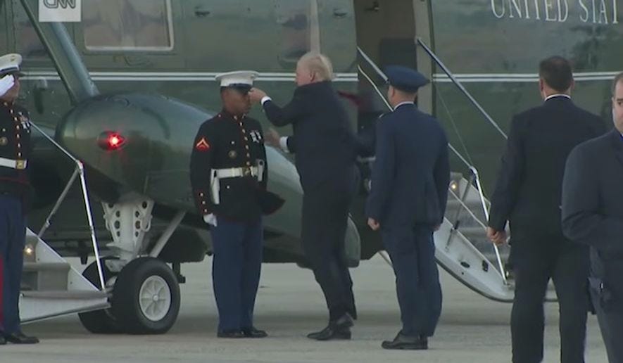Donald Trump retrieves Marine's hat on windy base: Video - Washington Times