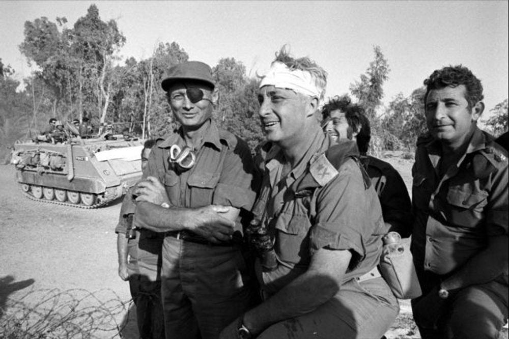 Israeli army Southern Command General Ariel Sharon (C) with Defense Minister Moshe Dayan during the Yom Kippur War in October 1973 on the western bank of the Suez Canal in Egypt.