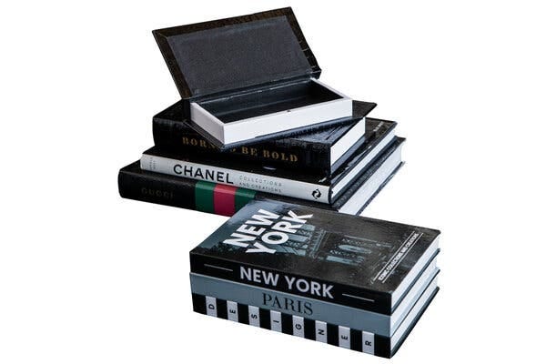 Stacks of fake books that double as storage spaces. Some of the books’ spines carry the words “London,” “Paris” and “Chanel” to connote sophistication on the owner.