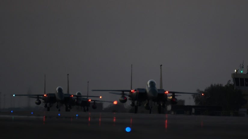 Military aircraft land at an air station.