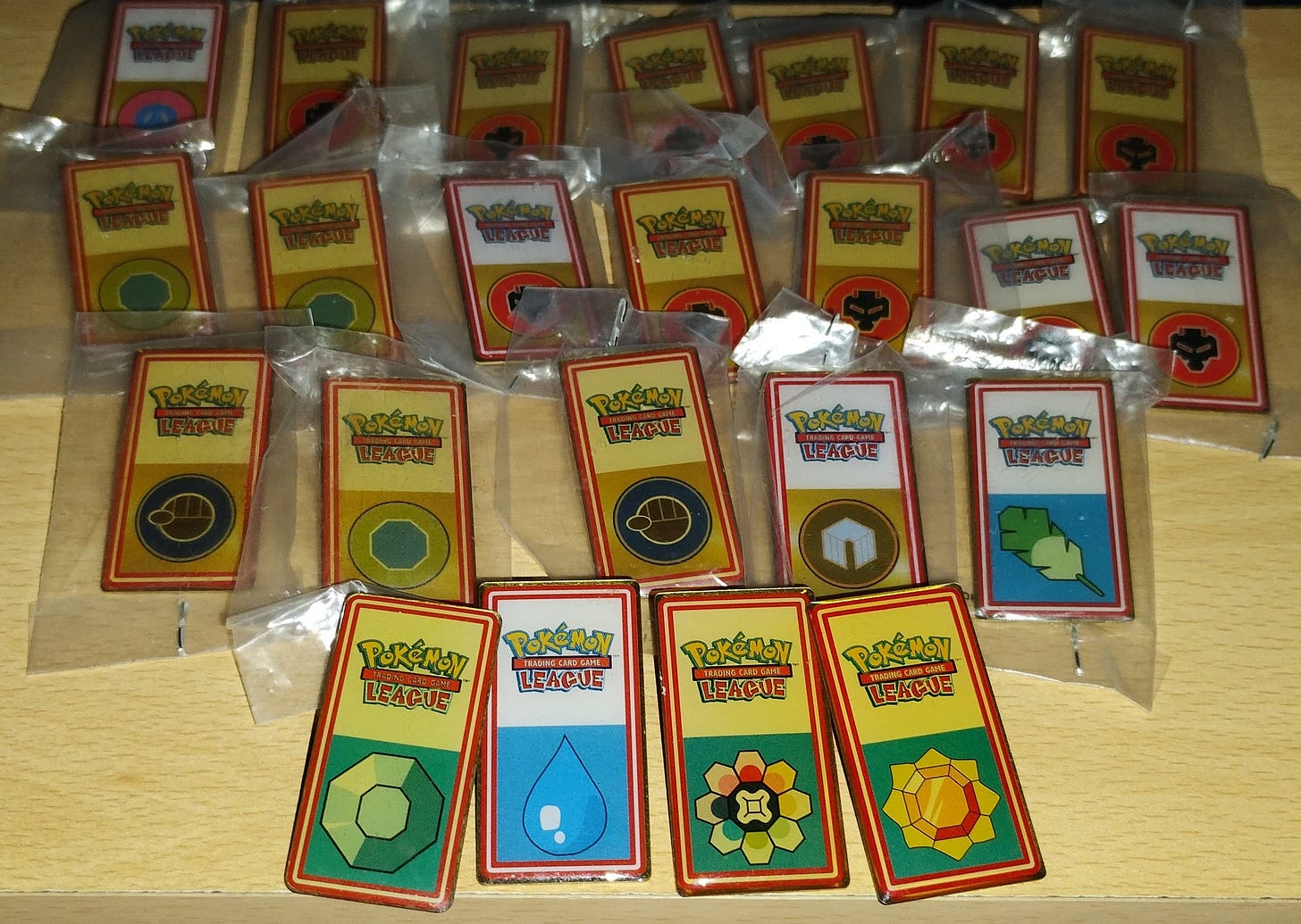 These Pokémon badges were given away at Pokémon Trading Card Game Leagues during the late 90s and early 2000s