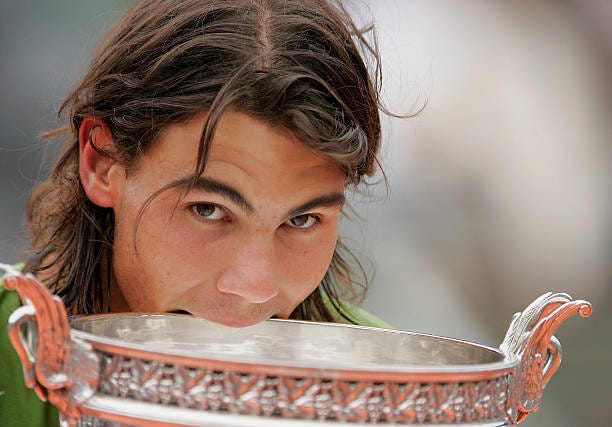 Rafael Nadal of Spain celebrates with the trophy at the end of the Mens Final match on the fourteenth day of the French Open at Roland Garros on June...