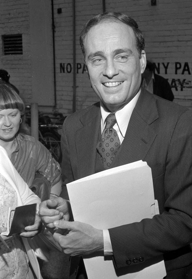 A person in a suit holding papers
AI-generated content may be incorrect. A person in a suit holding papers
AI-generated content may be incorrect.