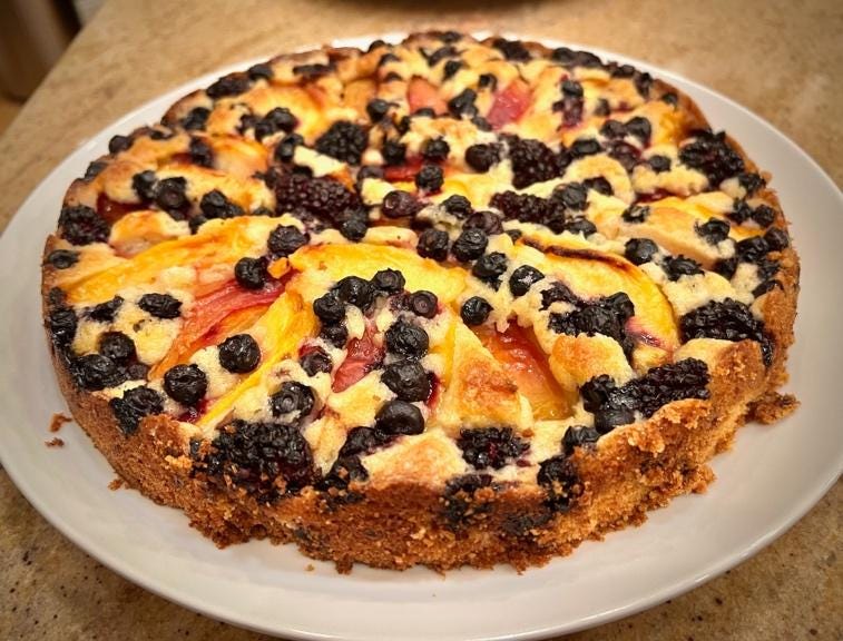 A pie with fruit on a plate

Description automatically generated