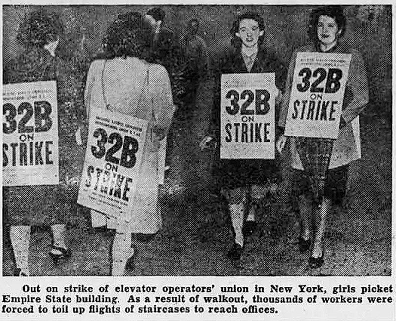 Blurry black and white newspaper photo from 1945 shows striking female elevator operators wearing placards that read ‘32B on strike’. Caption reads: ‘Out on strike of elevator operators’ union in New York, girls picket Empire State Building. As a result of walkout, thousands of workers were forced to toil up flights of staircases to reach offices.’