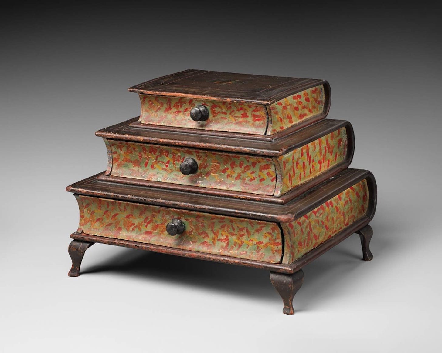 Maker unknown, graduated, three-tiered, footed box in book form c. 1870. American [Maine], painted wood (yellow poplar, birch). 18.0 x 23.0 x 16.3 cm. Gift of Lynn and Bruce Heckman, 2023