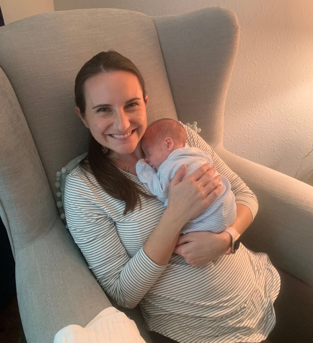Mom holding a newborn in a rocker Mom holding a newborn in a rocker