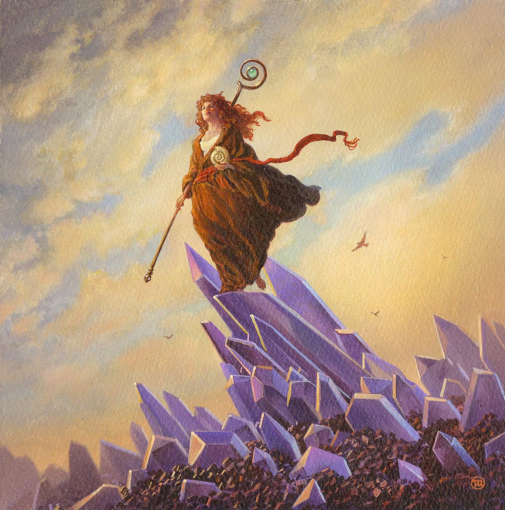 A woman in brown robes stands atop on diagonal outcrop of amethyst crystals set against a background of warm clouds and a hint of blue sky. Her long, curly red hair blows in the wind as does the thick brown cloak she's wearing and the red sash at her waist. In one hand, she carries a staff topped with a swirl ending in a green stone. In her left hand, she holds an ammonite fossil.