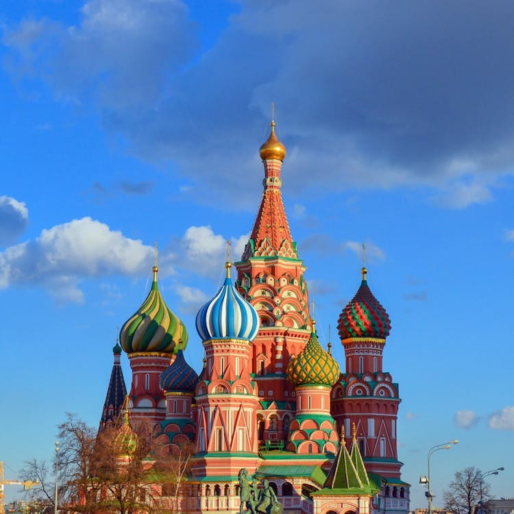 Free Colorful domes of St. Basil's Cathedral against a vibrant blue sky in Moscow, Russia. Stock Photo
