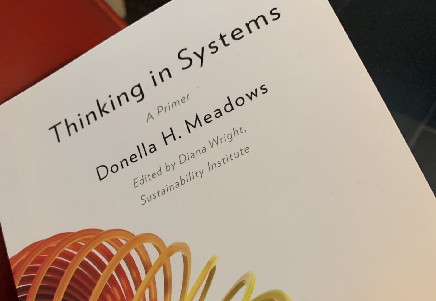 Photograph of the cover of “Thinking in Systems”, a book by Donella H. Meadows