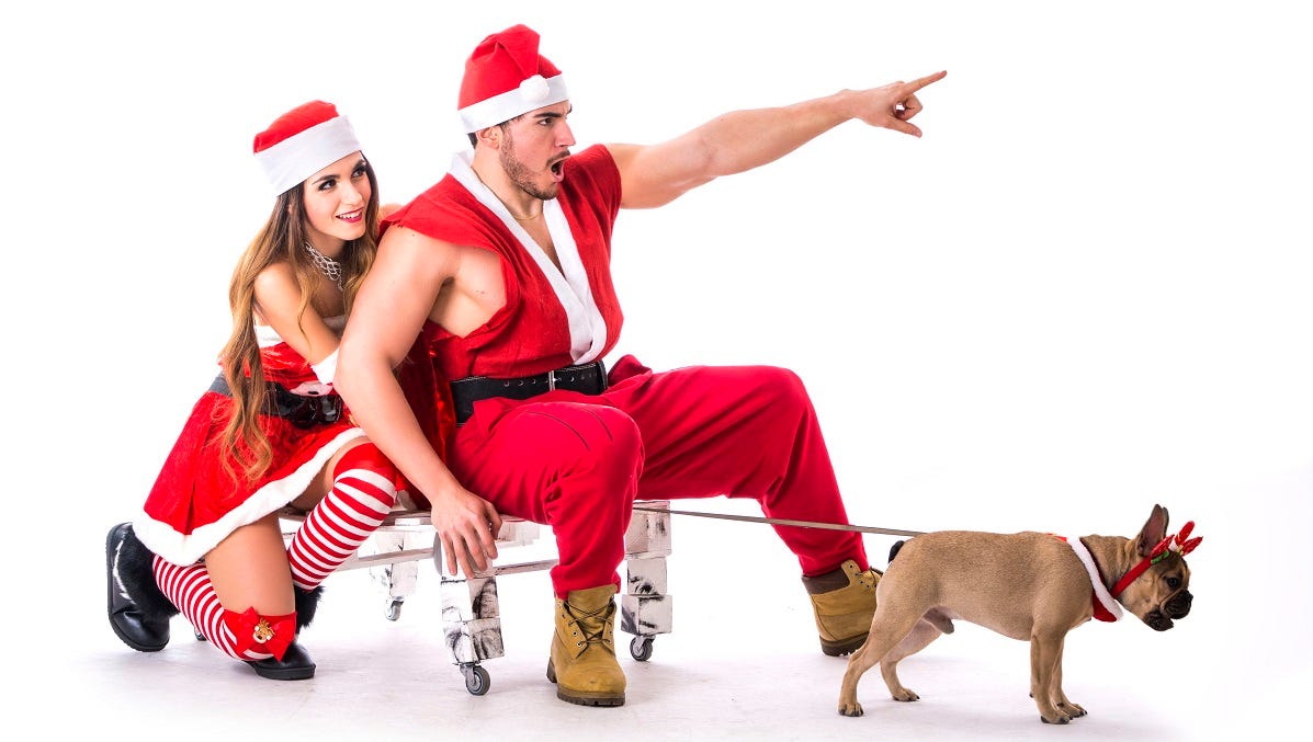 Sexy Man woman in santa outfits with pug dog leading sleigh mttg