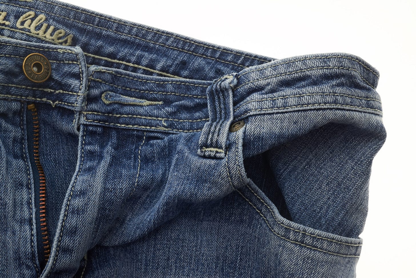 A pair of unzipped and unbuttoned blue jeans