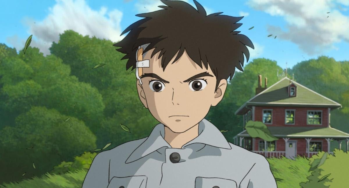 Still image of Mahito from the Boy and the Heron standing in front of a house and trees.