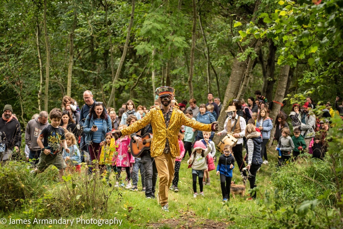 Group of families and musicians in the woods. James Armandary Photography