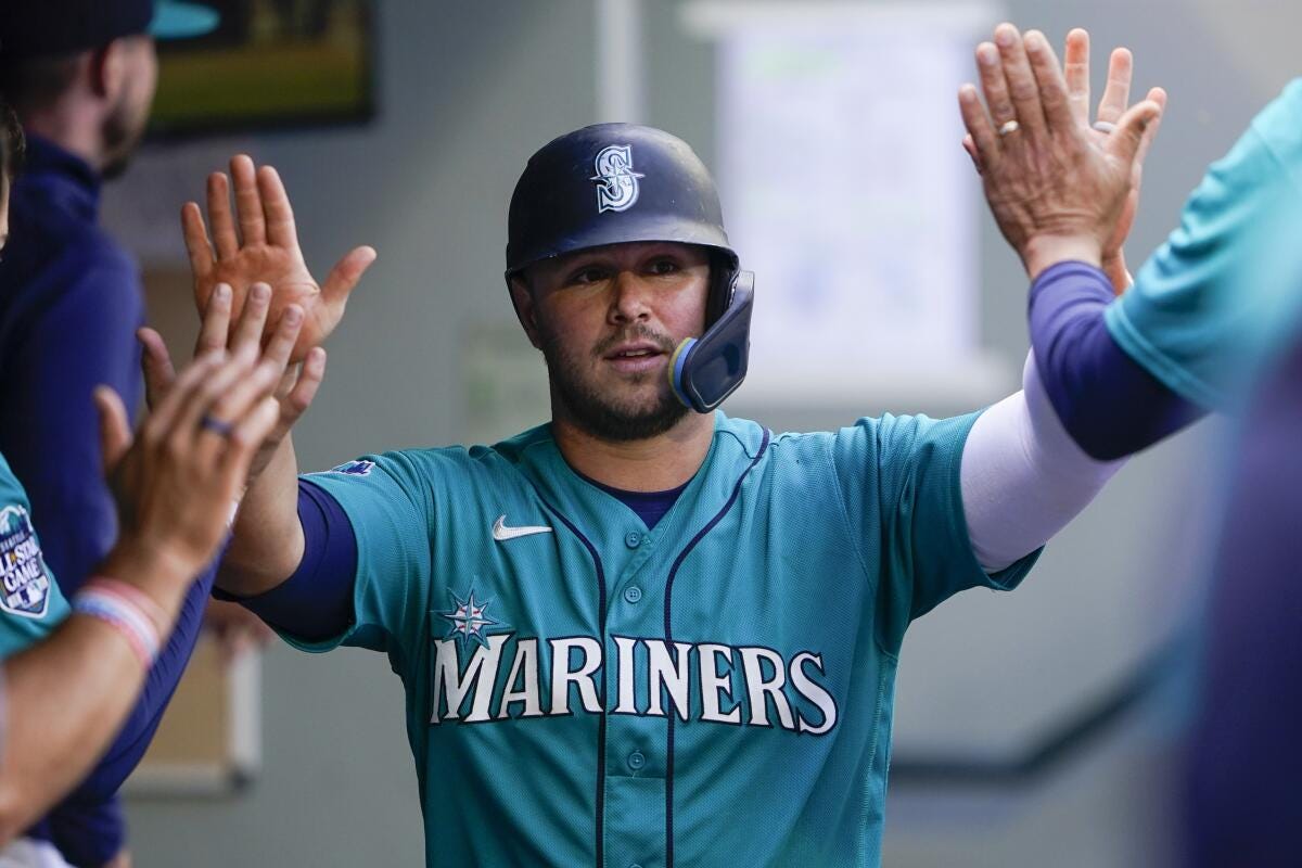 FILE - Seattle Mariners' Ty France is greeted in the dugout after scoring against the Los Angeles Angels during the fifth inning of a baseball game Sept. 13, 2023, in Seattle. First baseman France and right-hander Logan Gilbert were among seven players who agreed to one-year contracts with the Mariners on Thursday, Jan. 11, 2024, avoiding salary arbitration. (AP Photo/Lindsey Wasson, File)