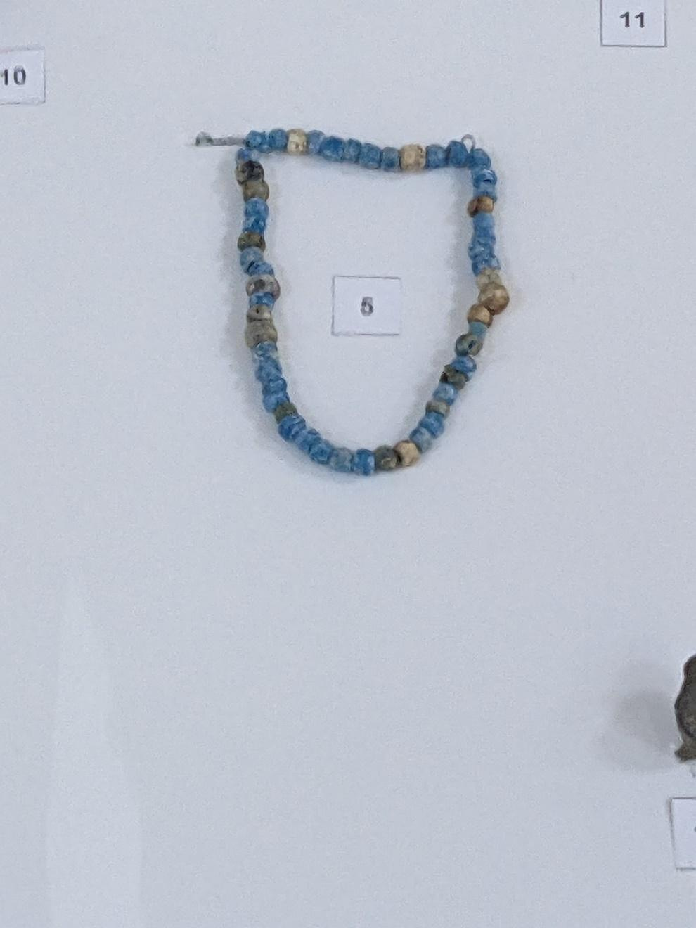 A necklace on a wall

Description automatically generated