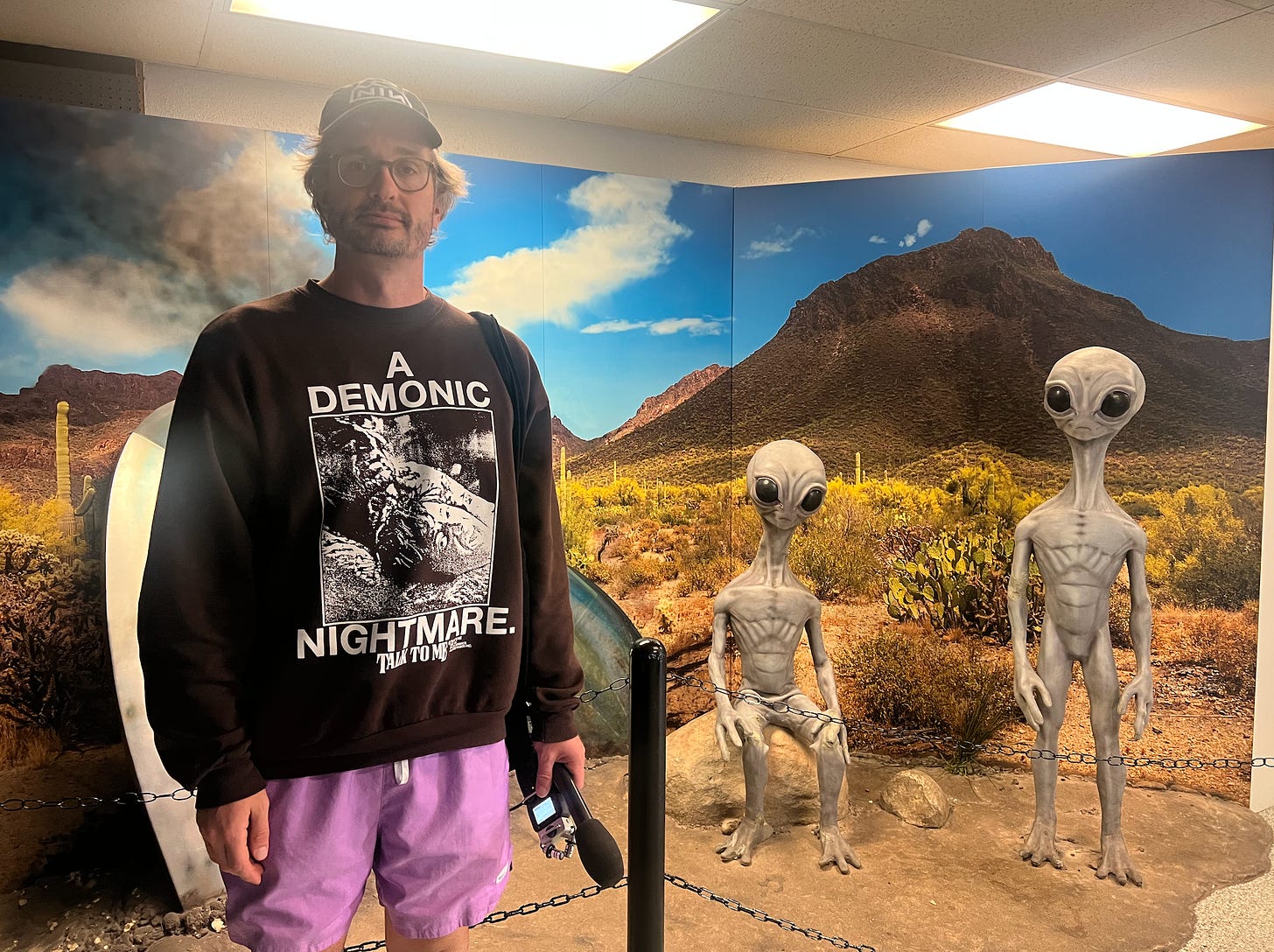 Me in front of a UFO display featuring life size alien greys
