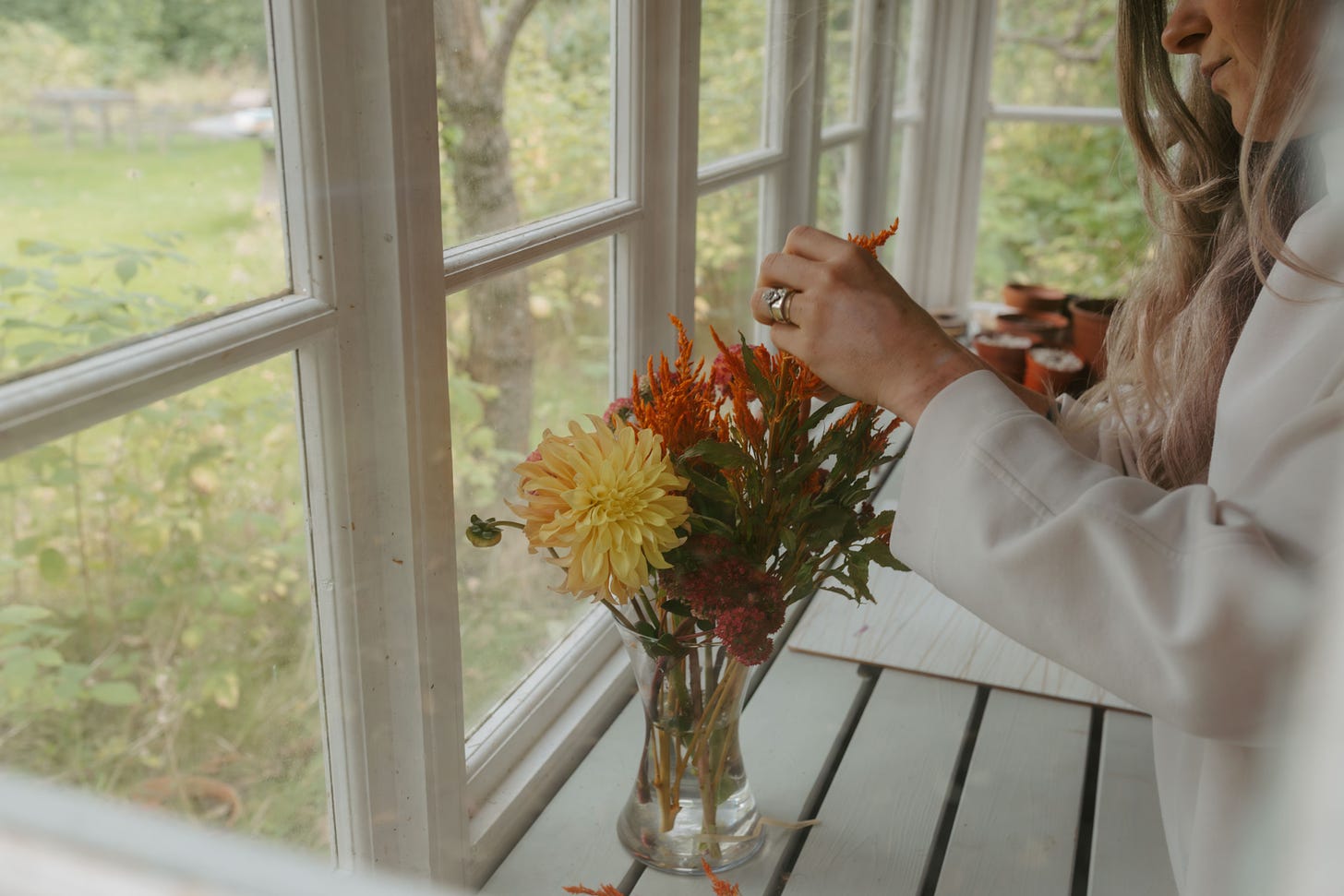 woman in shed flower arranging