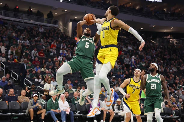 Malik Beasley of the Milwaukee Bucks shoots over Tyrese Haliburton of the Indiana Pacers during the second half of game five of the Eastern...