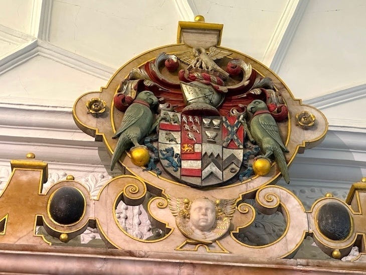 A coat of arms with parakeets on it