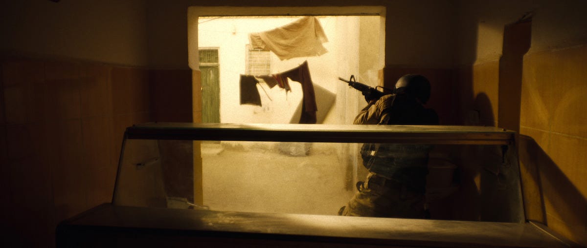An Army Ranger takes cover behind a doorway in Mogadishu
