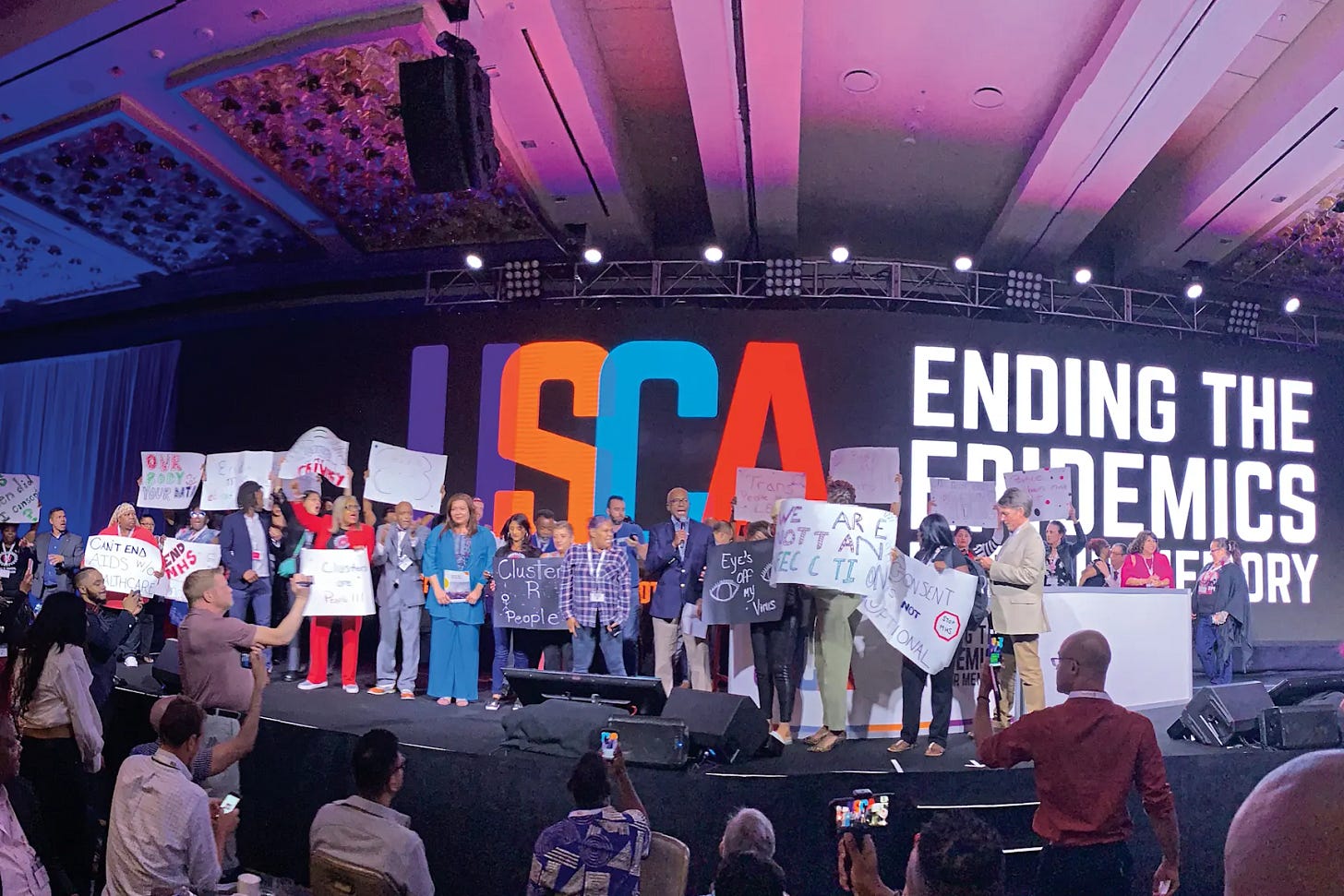 HIV community members protest the use of molecular surveillance onstage at the 2019 United States Conference on AIDS. POZ/Jennifer Morton HIV community members protest the use of molecular surveillance onstage at the 2019 United States Conference on AIDS. POZ/Jennifer Morton