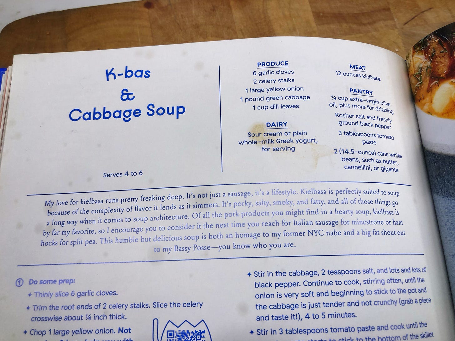 The recipe page for K-bas & Cabbage Soup in Molly Baz's "Cook This Book". It has many spatter and drip stains on it. 