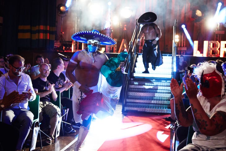 Luchadores running into the audience