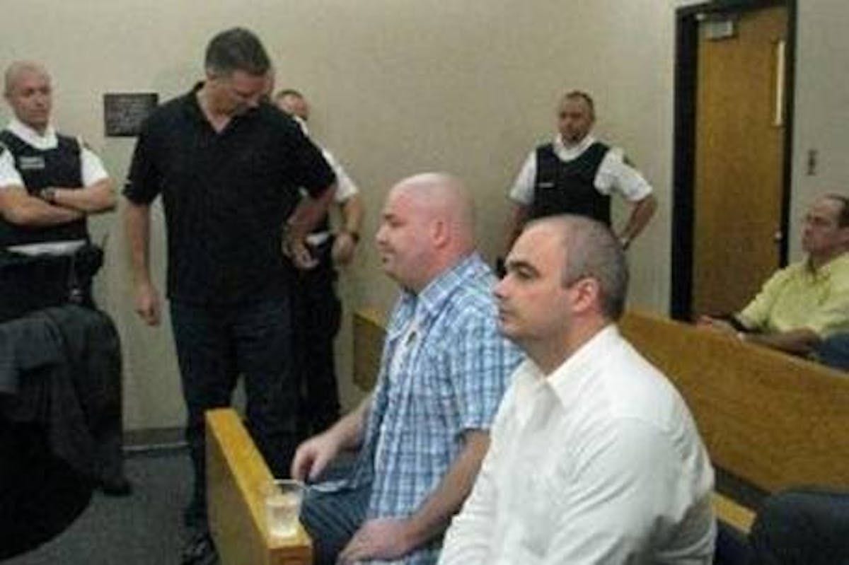 Patrick Champoux (in black shirt) is escorted into court in St. Johns Tuesday to join John Stanley (centre) and  Patrick Dickson in the prisoners dock. The trio pleaded guilty to drug charges laid as part of Operation Roadrunner.  Photo by Alisha Morrissey/The Telegram