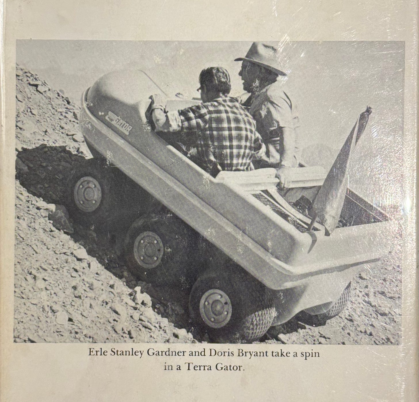 Book jacket photo of Erle Stanley Gardner and a friend driving a vintage ATV in the desert