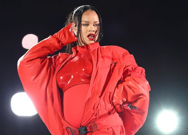 Rihanna performed a 13-minute set during her halftime show and teased her baby news by occasionally caressing her belly.