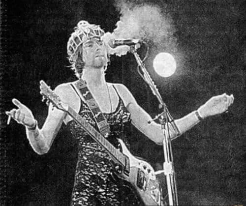 Cobain in concert wearing a black lace dress and a tiara