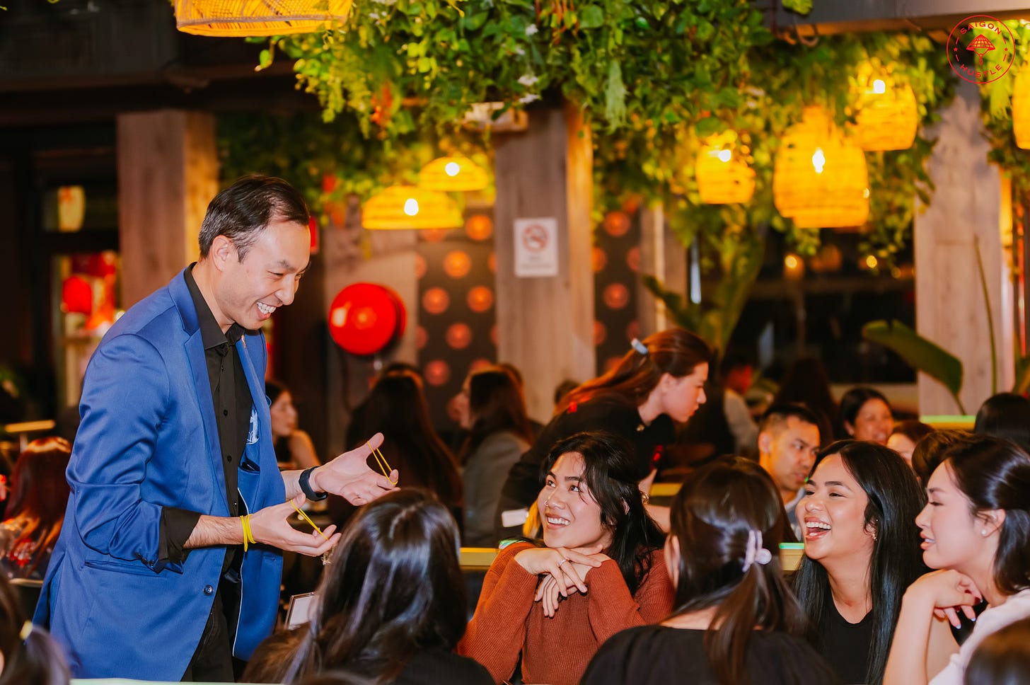 David Ung performing magic for people at a restaurant