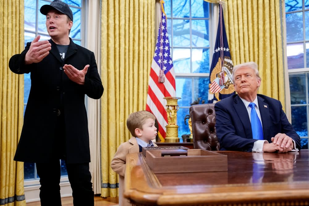 Elon Musk, accompanied by President Donald Trump, and his son X Musk, speaks during an executive order signing in the Oval Office at the White House.