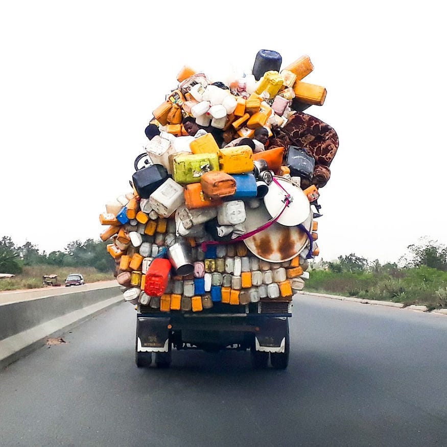 an open bed truck loaded to the max with a mountain of stuff