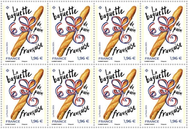 A postage stamp showing a baguette with a red, white and blue ribbon around it and the words “La baguette de pain française.” 